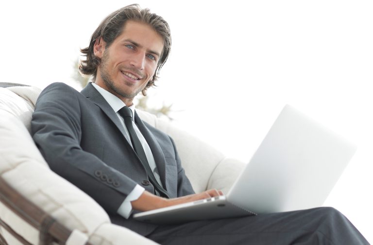 businessman with a laptop sitting in a stylish comfortable chai